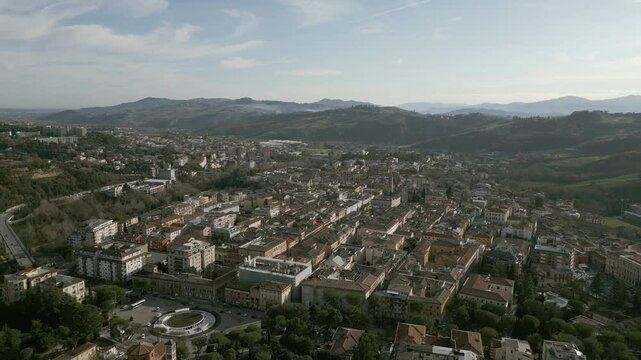 A stunning drone view of Teramo, Italy: rolling green hills, historic architecture, and vibrant cityscapes nestled in the Apennines. Breathtaking aerial perspectives!