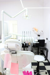 Dental office with a patient chair and medical equipment for dental treatment.