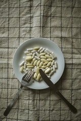A lot of pills and vitamins on a plate, anti-aging diet culture