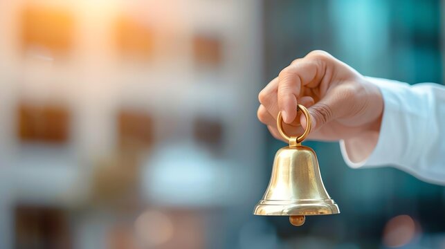 Achievement highlighted by a professional ringing a symbolic bell in celebration of a milestone.