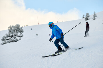 Skier in Blue Jacket Racing Down a Snowy Mountain Vibe. Winter adventure vibe and outdoor sports concept.