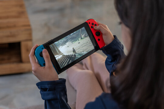 Jaen, Spain - January 2, 2025 : A girl playing Nintendo Switch videogame "Zelda, Breath odf wild." at home
