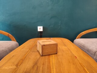 Wooden Table with tissue box Between Two Armchairs in a Minimalist Room