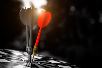 Dark bulls eye target or bullseye have red dart arrows throw hitting challenge the center of a...