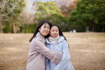Obraz premium 冬の朝の公園で元気で楽しく遊んでいる子供姉妹の姿