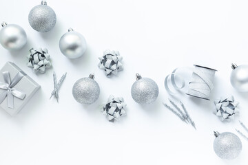 Silver colored Christmas and New Year decorations on white background, top view