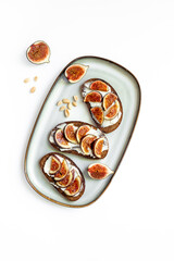 Healthy vegetarian meal snack on the table - fig sandwiches with cheese and honey, top view