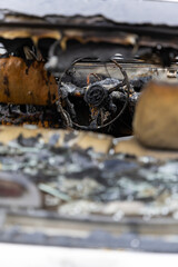 Interior of a burned passenger car. Major damage to the vehicle due to fire. Photo taken on a cloudy day