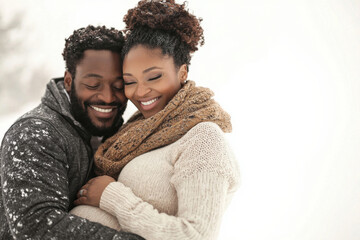 Obraz premium Pregnant couple embracing with joyful smiles