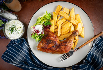 Appetizing baked chicken leg quarter.