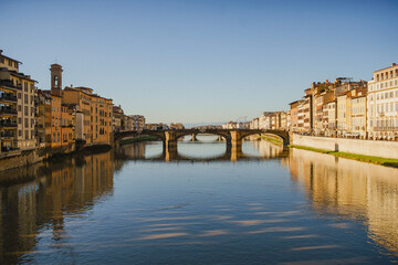 The embankment of the Arno River in Florence. Renaissance architecture. Reflection of houses in the water. Florence Bridge: Ponte Vecchio