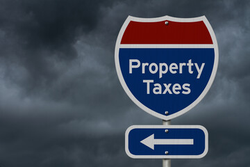  Property taxes road sign with arrow under stormy cloud