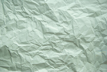 Wrinkled grey paper background with a textured appearance.