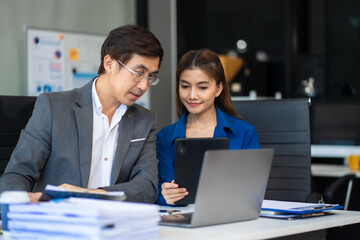 Business team working on a project in the office or reviewing and discussing a business project.