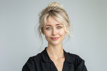 Her black attire, set against a white background, showcases a respectful and poised style ideal for formal settings.