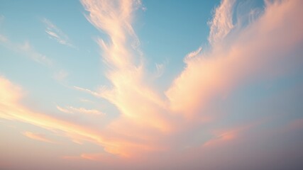 Pastel Sky Hues at Dawn Soft, wispy clouds painted across a tranquil expanse of light blue and peach