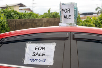 The car is parked on the street with a limited time offer for sale