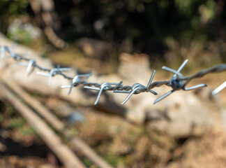 Barbed wire on a fence, close-up view
