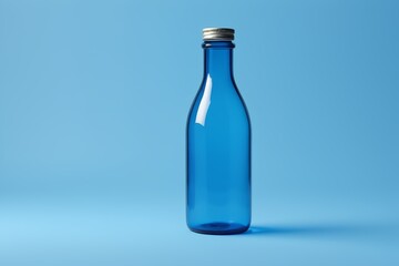 a close up of a blue bottle with a silver lid