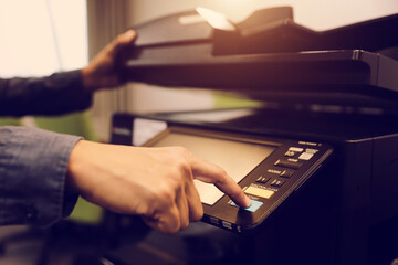 Men use photocopy or copier machine office workplace equipment for make a copy paper or photocopier for scanning document and photocopying service maintenance concepts.