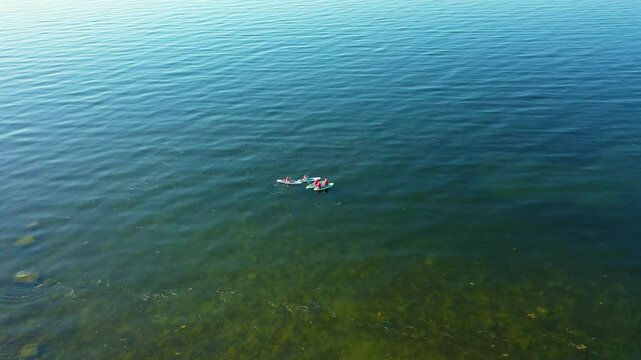 People row canoes on the lake .Aerial 4K video from drone .Estonia, Paldiski. (Series)