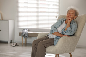 Loneliness concept. Sad senior woman sitting in armchair at home