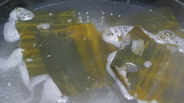 Making soup stock with kombu (kelp) to prepare nabe dishes, an important process in Japanese cuisine.