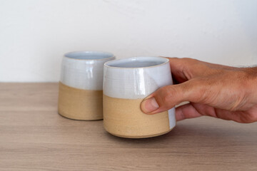 Handmade ceramic coffee or tea mugs on wooden surface. High quality photo