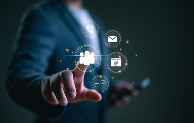 Contact us or Customer support hotline, people connect. Businessman using smartphone and touching on virtual screen contact icons (email, address, live chat, telephone, customer service).