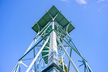 The Slovanka Iron Lookout Tower rises against a clear blue sky in the Jizera Mountains, providing panoramic views of the surrounding landscape and inviting visitors to explore.