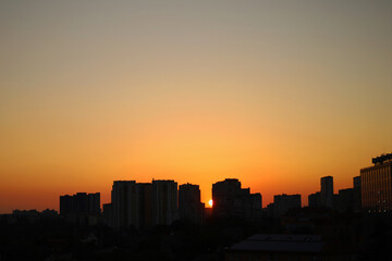 silhouette of high-rise buildings of the city on the background of the sunset