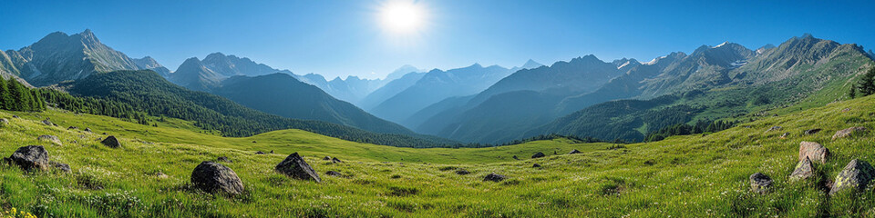 Verdant pastures amidst rugged mountain scenery and a clear, bright sky