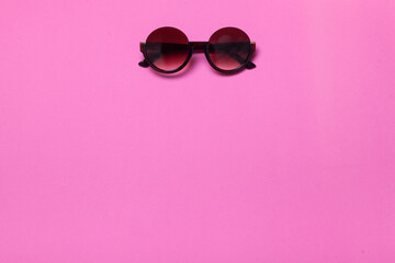 luxury fashionable sunglasses on pink and purple background, flatlay top view