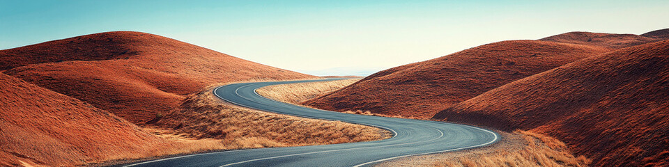 Curved road between red-brown hills, leading to the horizon