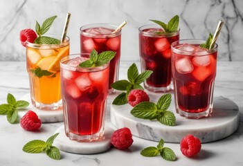 A close-up of a refreshing raspberry cocktail with mint leaves and ice cubes on a marble background