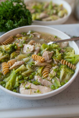 Healthy chicken soup with green vegetables and whole wheat pasta