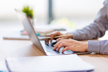 Asian businesswoman work on laptop computer at the office with calculator document on desk, doing...