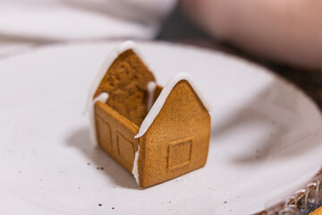 gingerbread in the form of a christmas tree. gingerbread man with cinnamon on a white plate on a wooden table. christmas and new year concept.
