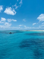 Australia's ocean featuring the Great Barrier Reef below and sand in the back