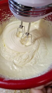 Mixing Creamy Batter in a Red Bowl - Baking Preparation Close-Up