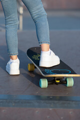 child's foot on a skateboard in a white sneaker rear view. High quality photo © Svitlana