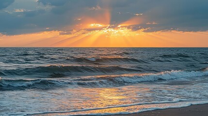 Fototapeta premium A serene sea at sunrise, with a colorful sky and glowing sunset. A peaceful beach landscape meets the horizon during quiet dusk and warm summer.