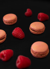 macaroons of different colors on a black background