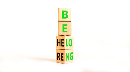 Belonging and belong symbol. Concept words Be here Belong on beautiful wooden block. Beautiful white table white background. Business motivational belonging and belong concept. Copy space.