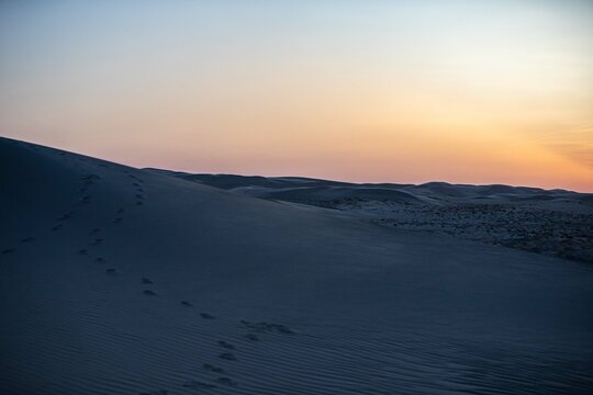 Khongor Sand Dunes in the Gobi Desert of Mongolia. Vast golden sand dunes stretching across the desert landscape, surrounded by mountains and showcasing the unique beauty of one of Mongolia&rsquo;s most ico