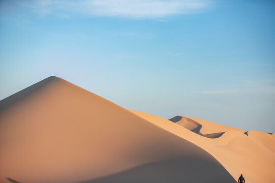 Khongor Sand Dunes in the Gobi Desert of Mongolia. Vast golden sand dunes stretching across the desert landscape, surrounded by mountains and showcasing the unique beauty of one of Mongolia&rsquo;s most ico