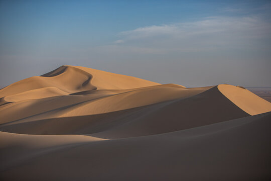 Khongor Sand Dunes in the Gobi Desert of Mongolia. Vast golden sand dunes stretching across the desert landscape, surrounded by mountains and showcasing the unique beauty of one of Mongolia&rsquo;s most ico