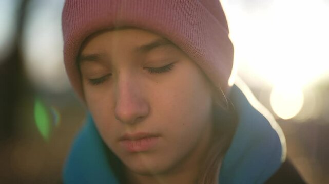 Go to school in fall morning or rest in park in weekend, portrait of teen girl. Calm emotionless child walking down street in city in sunny autumn day, pretty face of adolescent girl, walk in forest