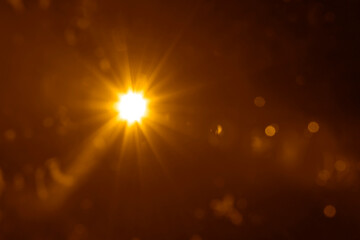 Obraz premium golden sunbeam sunlight beam sunshine sunset bright. Isolated yellow light rays animation. Shine or sun effect on black screen background. Glitter, shiny, bright, flare. orange sunrays, bokeh