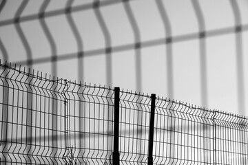 Obraz premium Barbed wire net Fence Sunset isolated on white background. sunset behind the wires. Mesh Steel and Barbed Wire, Sunset with Red and blue heaven. illustration.
